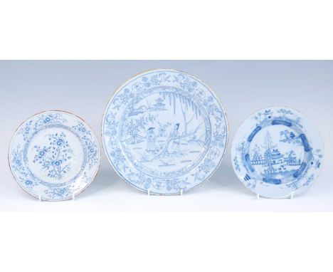 A Liverpool blue and white delftware charger, circa 1740, decorated with eastern figures within a landscape, dia.30cm, togeth