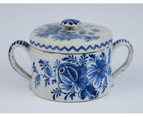 A Lambeth blue and white delftware posset pot or caudle cup and cover, circa 1750, flanked by twin loop handles, decorated wi
