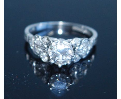 A white metal diamond solitaire ring, featuring a round brilliant cut diamond in a claw setting, with two Old European, one s