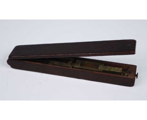 A late George III mahogany guinea balance, the hinged lid revelaing a folding brass scale with interior paper label for Wilki