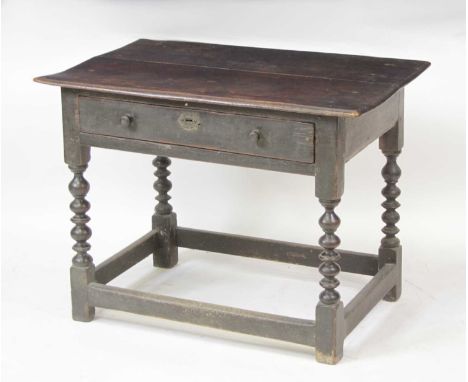 A circa 1700 joined oak single drawer side table, having a two-plank top and raised on bobbin turned supports united by low s