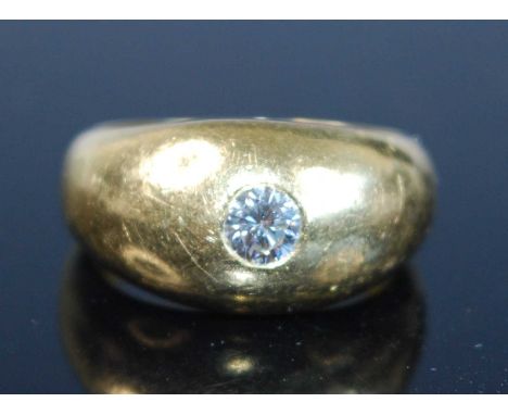An 18ct yellow gold diamond set signet ring, having a round brilliant cut diamond flush set within a domed head, diamond dime