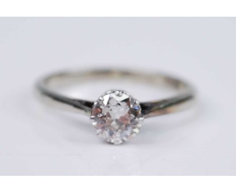 A white metal diamond solitaire ring, featuring a transitional round brilliant cut diamond in an eight-claw pierced collet se