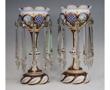 A pair of Bohemian blue and white overlaid glass table lustres, 19th century, each enamel decorated with flowers and heighten