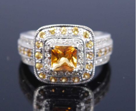 A 14ct white gold, citrine and diamond square cluster ring, featuring a centre square cut citrine within a double halo of 16 