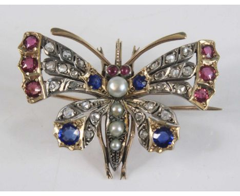 A yellow and white metal multi-stone butterfly brooch, the wings set with 24 rose cut diamonds, six round rubies and six roun