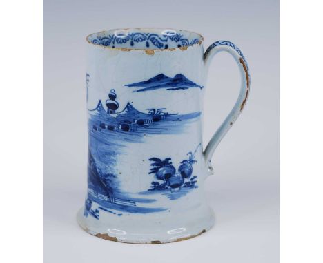 An English blue and white delftware tankard, probably London, circa 1760, decorated with a pagoda within an eastern landscape