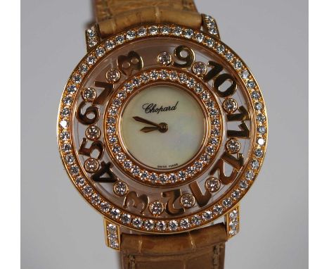 A lady's Chopard 18ct gold 'Happy Diamonds Happy Time' wristwatch, having a signed mother of pearl dial within a wide bezel c