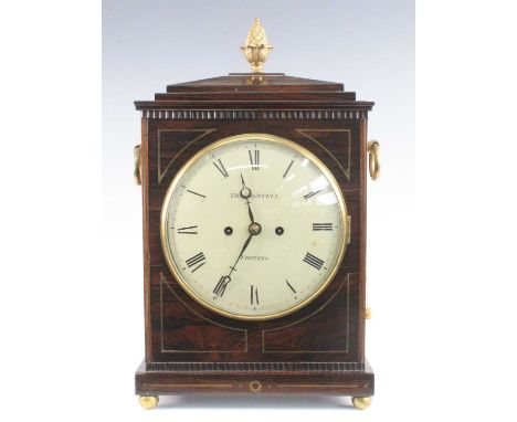 Thomas Restell of Tooting - a Regency rosewood cased bracket clock, the case having a pineapple finial over a stepped archite