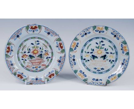 A pair of English polychrome delftware plates, probably Lambeth, circa 1740, each decorated with a basket of flowers, dia.23c