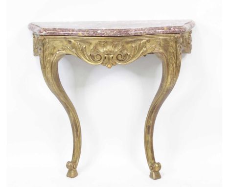 A continental giltwood and gesso marble topped console table, having shell and acanthus leaf swept frieze, 20th century, w.85