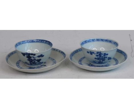 A pair of Chinese blue and white porcelain tea bowls and saucers, circa 1750, decorated with prunus blossom within a diaper b