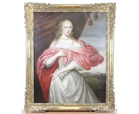 Circle of Sir Godfrey Kneller (1646-1723) - three-quarter length portrait of a lady standing within a landscape, oil on canva