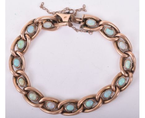 A 9ct gold and opal set chain link bracelet, safety chain broken and one cabochon missing, 14g