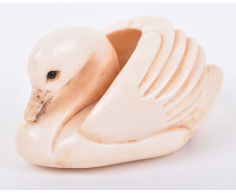 ^A 19th century Japanese carved ivory netsuke, Meiji period, in the form of a swam, signed, 4.5cm