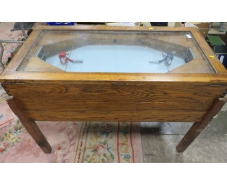 A VINTAGE 'R &amp; W' ICE HOCKEY GAME, of mainly wood construction, with glaze top, fitted with coin operated mechanism, A/F,