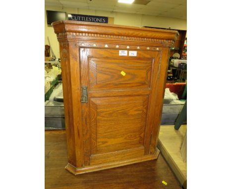AN ANTIQUE OAK HANGING CORNER CUPBOARD WITH MOTHER-OF-PEARL INLAY 