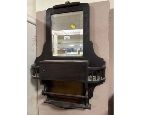 An Edwardian mirrored shelf with glazed panel 