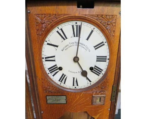 A WALL MOUNTED NATIONAL TIME RECORDER OAK CASED CLOCKING IN CLOCK, H 119 cm 