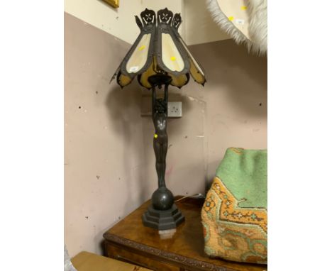 A large 20th century Tiffany style table lamp model as a naked lady holding the shade standing on a ball H 96 cm 
