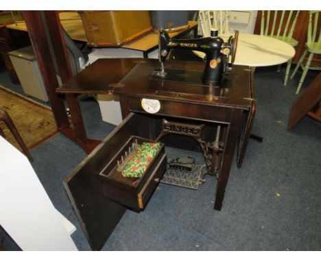 A vintage singer electric sewing machine in oak cabinet 