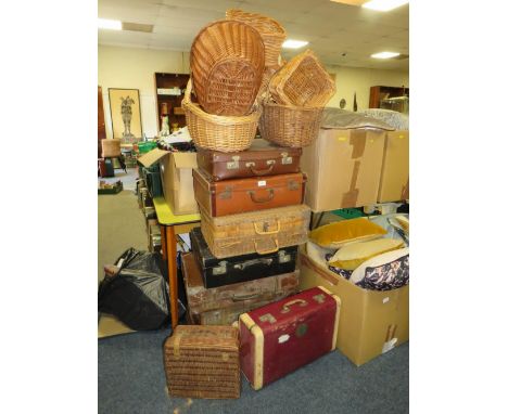 A large collection of vintage suitcases, wicker hampers and baskets 