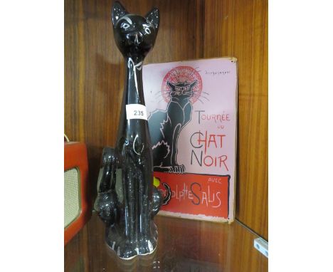 A VINTAGE BLACK CERAMIC CAT TOGETHER WITH A REPRODUCTION TOURNEE DU CHAT NOIR ENAMEL SIGN 