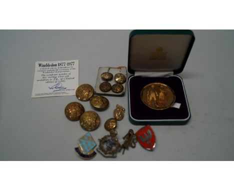 A cased Wimbledon centenary medallion 1877-1977, by Garrard; together with a quantity of enamel badges and brass buttons.