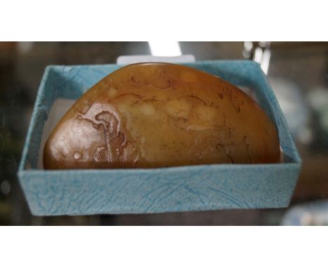 A Chinese yellow jade pebble, carved in shallow relief with figures in a landscape, 8cm high, (bruised).