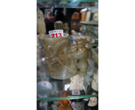 A Chinese carved celadon jade figural brush pot, 8.5cm high. Condition Report: This pot has natural inclusions and minor wear