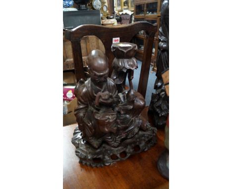 A Japanese carved hardwood immortal and tiger lamp base figure group, the tiger with inset eyes, 26.5cm high, on fitted hardw