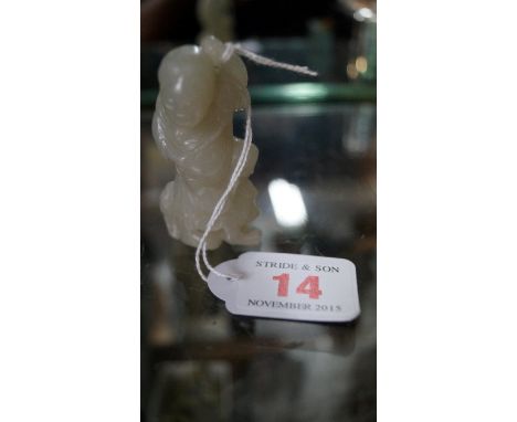 A Chinese carved celadon jade figure, standing on a crouching animal and with a cat at his feet, 6.5cm high. Condition Report
