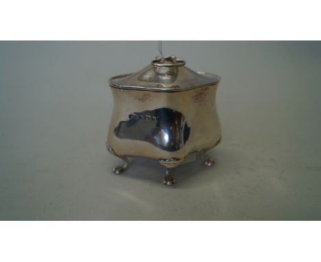 An Edwardian silver tea caddy, by S W Smith & Co, Birmingham 1904, of bombe form, with hinged lid and swing handle, 11cm high