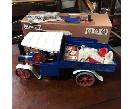 A Vintage Mamod model steam engine wagon. Comes with original box, fuel and funnel. Designed with a blue and white painted bo