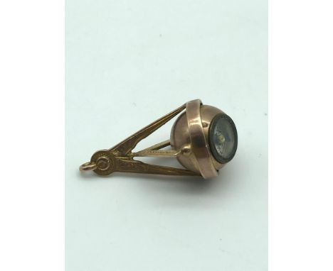 A Birmingham 9ct gold masonic pendant, fitted with a revolving compass [5.66g]