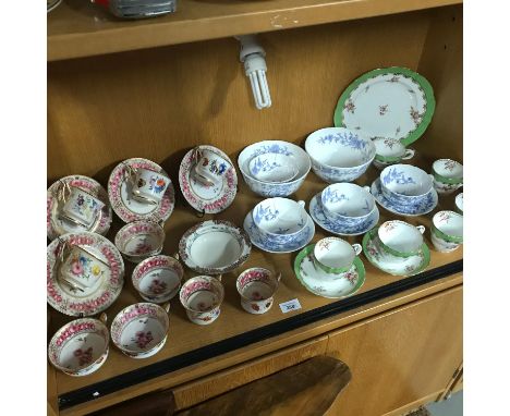 A shelf of antique tea sets to include, Davenport hand painted floral cups &amp; saucers, Coalport blue &amp; white dragon de