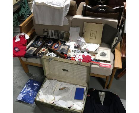 A Vintage midwifery travel case containing uniforms, photographs of nurses/ midwives, military photos, two wooden truncheons,