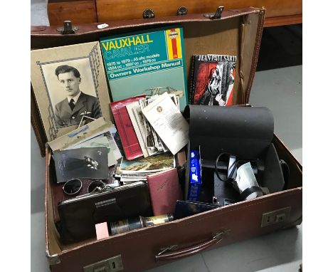 A Vintage case containing various collectables to include postcards, RAF Military photo, Polaroid camera and case, Binoculars