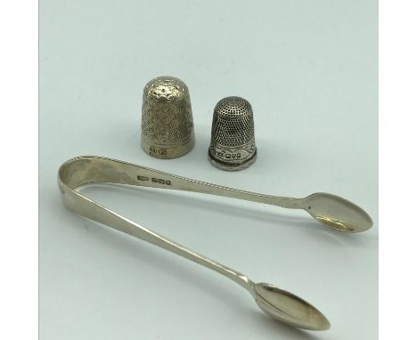 A set of Sheffield silver sugar tongs, together with a Chester silver Charles Horner thimble and one other stamped CH.