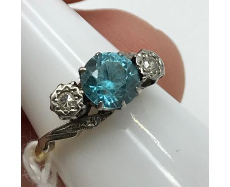 A Lovely example of An Antique 18ct gold and platinum ring set with a large single round cut blue topaz stone off set by two 