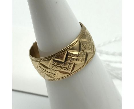 A Ladies 9ct gold engraved Wedding Band. Ring size K and weighs 3.3grams