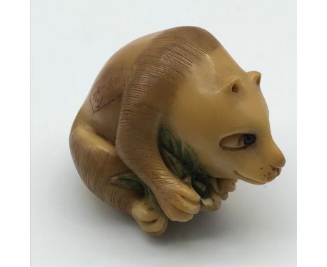 A Highly detailed Japanese hand carved Tagua nut netsuke of a sitting panda, Detailed with black bead eyes and signed by the 