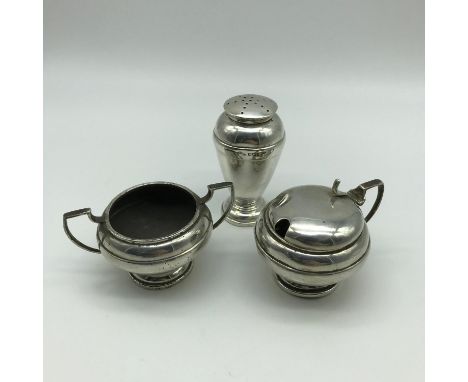 A lot of three Sheffield silver condiment pots and shaker pot by Walker and Hall.