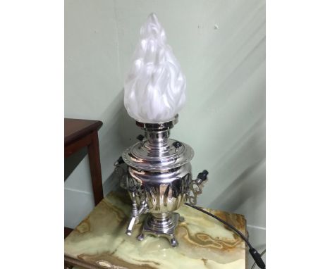 A Vintage samovar converted to a table lamp. Designed with a frosted glass flame shade. In a working condition.