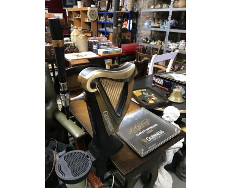 A Collectable Guinness harp shaped beer dispenser and wall plaque 