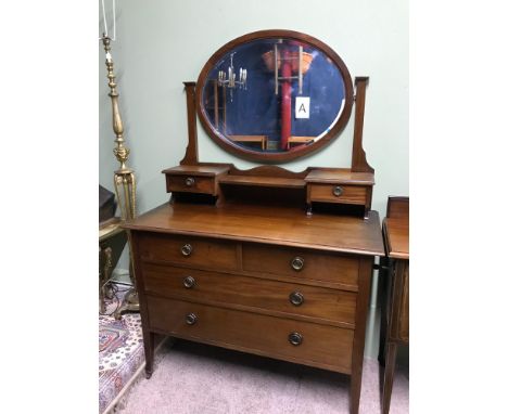 A Victorian Mahogany dresser. Designed with oval swivel mirror and two over two chest of drawers. Supported on square tapered