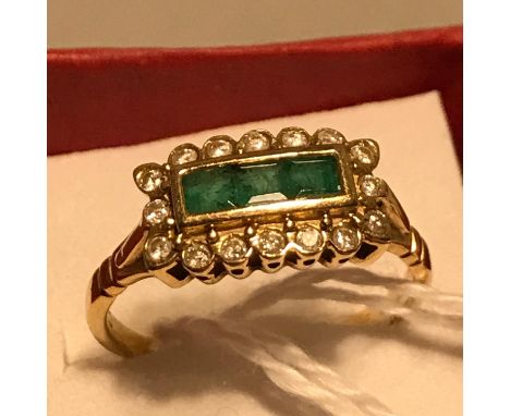 A Beautiful Antique ladies 18ct gold ring set with 3 Square cut Emeralds surrounded by Diamonds. Ring size R and weighs 4.08g
