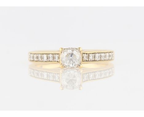 A diamond ring, set with a central round brilliant cut diamond, measuring approx. 0.40ct, flanked to either side with six rou