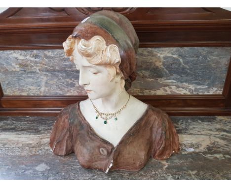 A bust of a woman wearing head scarf, signed to back.