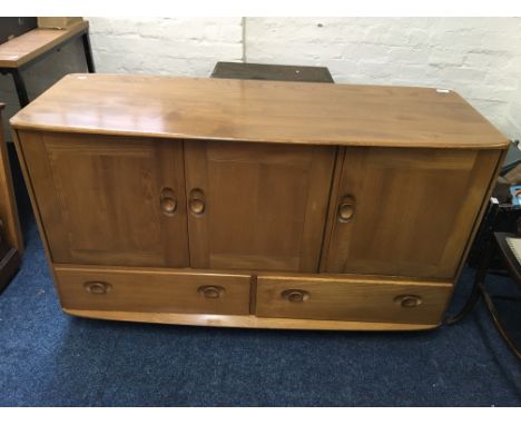 An "Ercol" oak sideboard fitted with three drawers and two doors.